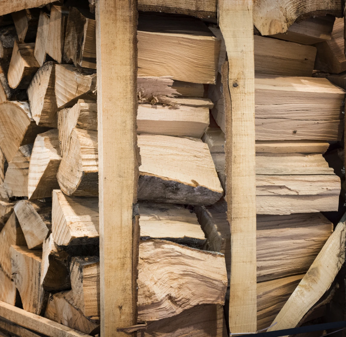 Stacked firewood in wooden crate
